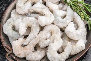 Frozen raw shrimp prawns in a rustic metal bowl with fresh rosem, a Food & Drink Photo by composter-box@mail.ru