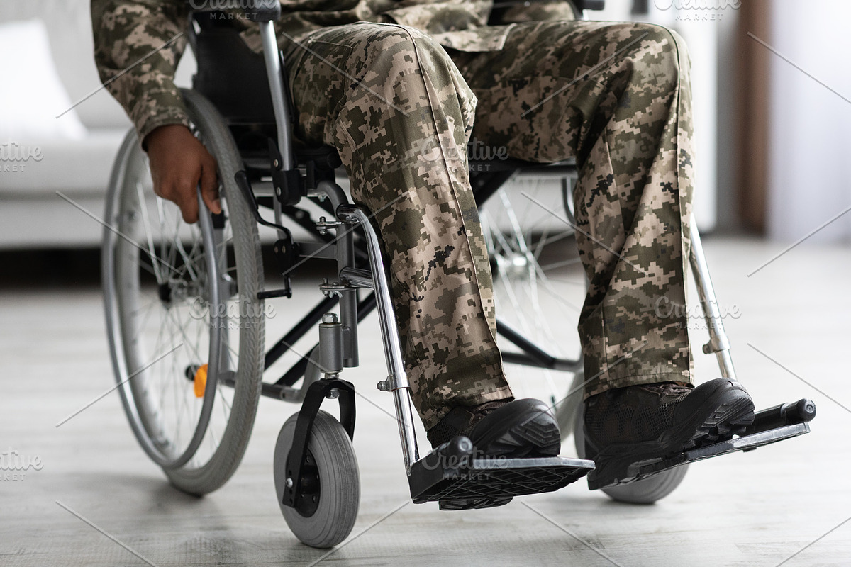 Legs of disabled african american military man in wheelchair, a Photo by Prostock-Studio (Photo 1 of 2)