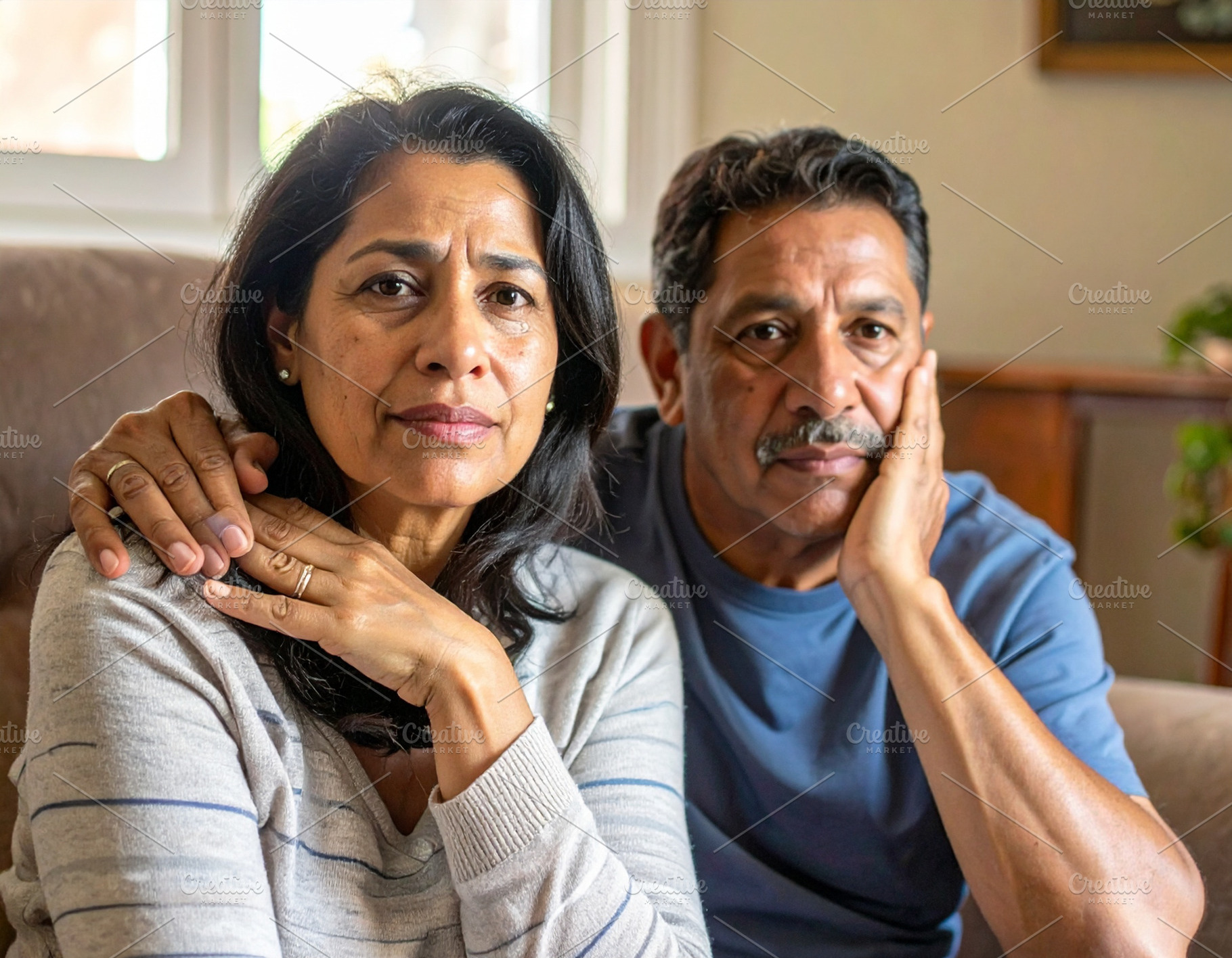 Middle age couple sitting on couch, one comforting the other aft, a Person Photo by DanFLCreativo
