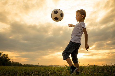 little boy playing in the field