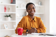 Portrait of happy young black woman working at office, a Photo by Prostock-Studio (Thumbnail 2 of 2)