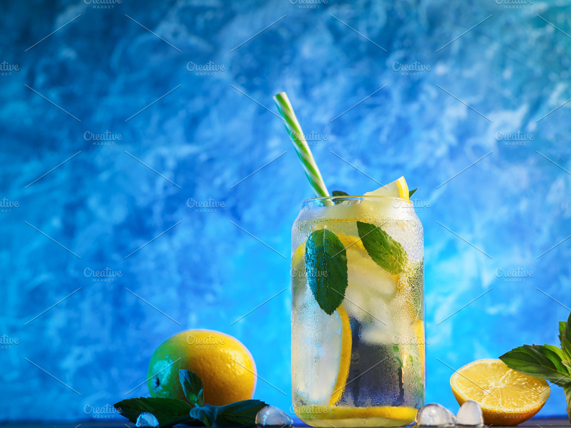summer cold lemonade with lemon and mint, blue background., a Food & Drink Photo by PavelKant