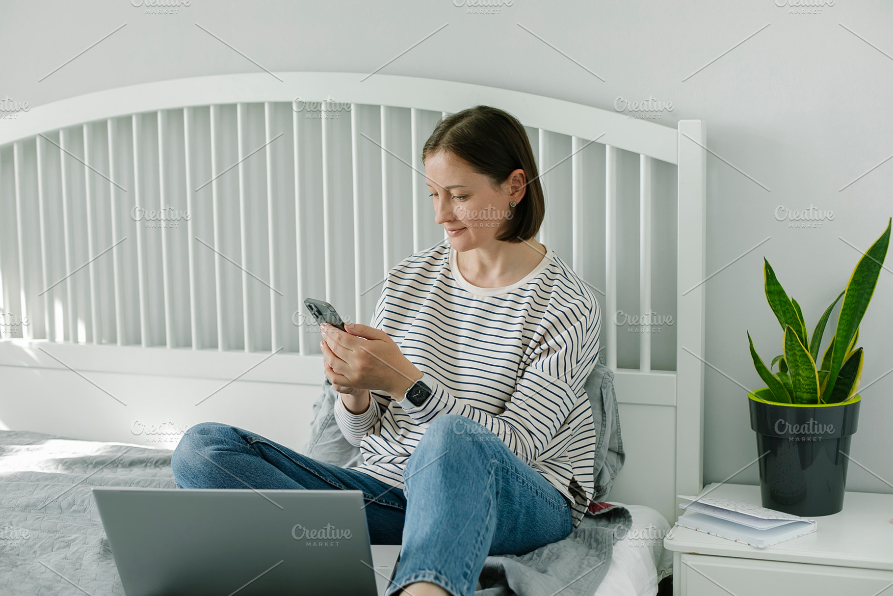Young woman working from home office. Freelancer using laptop, phone and the In, a Person Photo by Anikona