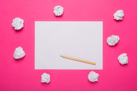White paper sheet on pink background