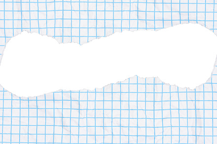 Piece of paper with a light blue grid pattern and a large, torn, a Background Photo by ndanko