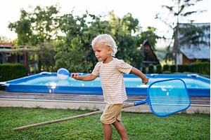 Smiling blond child playing in, a Nature Photo by HalfPoint