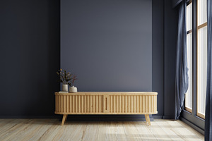 Modern living room decor with a tv cabinet and dark blue wall background.