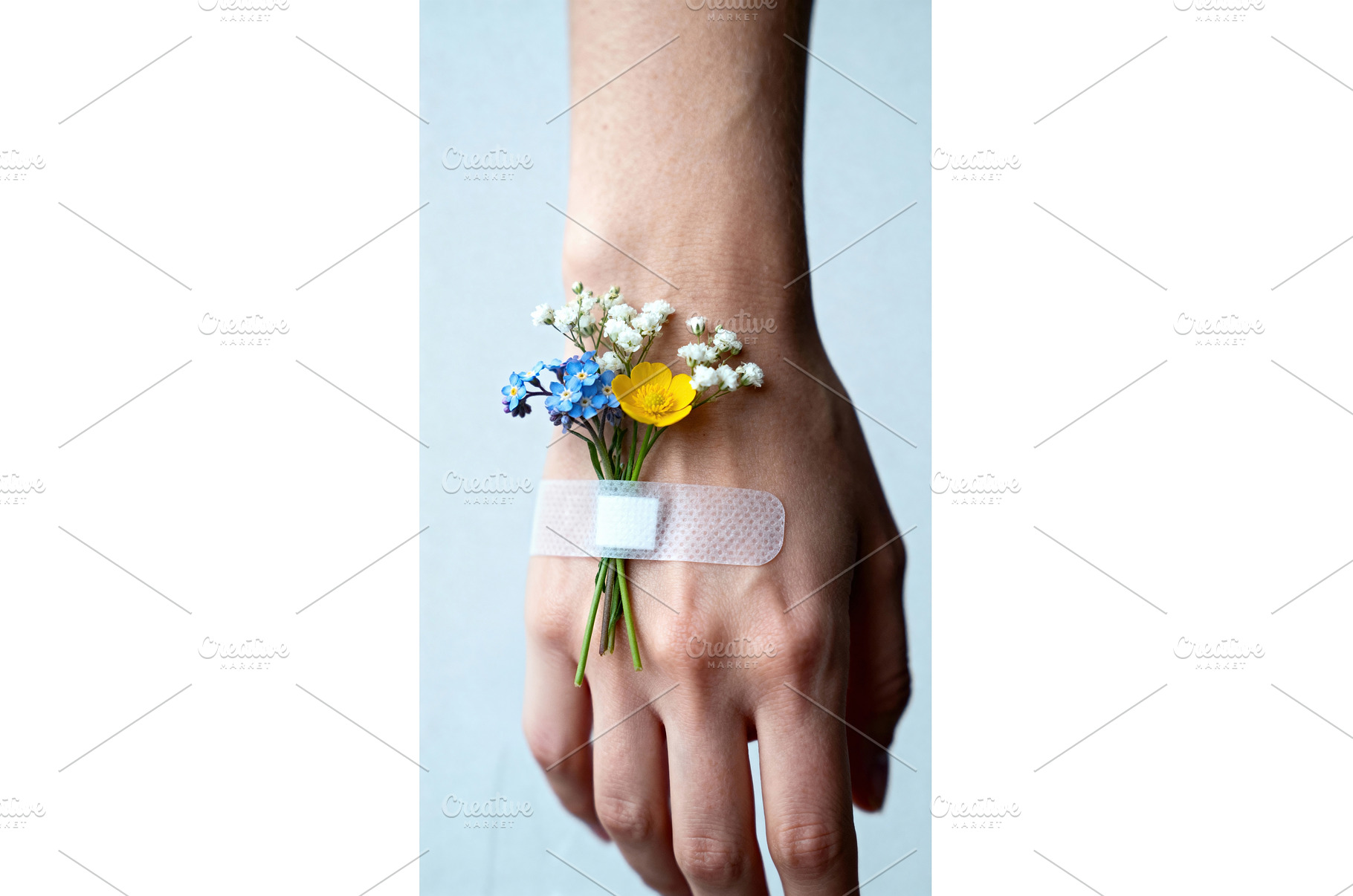 Hand with small wildflowers secured, a Health & Medical Photo by tilialucida