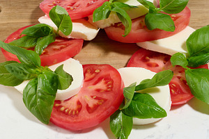 A close-up of a classic Caprese salad consisting of sliced, a Food & Drink Photo by ndanko