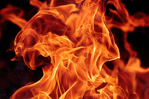 Dynamic close-up of vibrant flames with sparks, a Background Photo by AlyaAnd