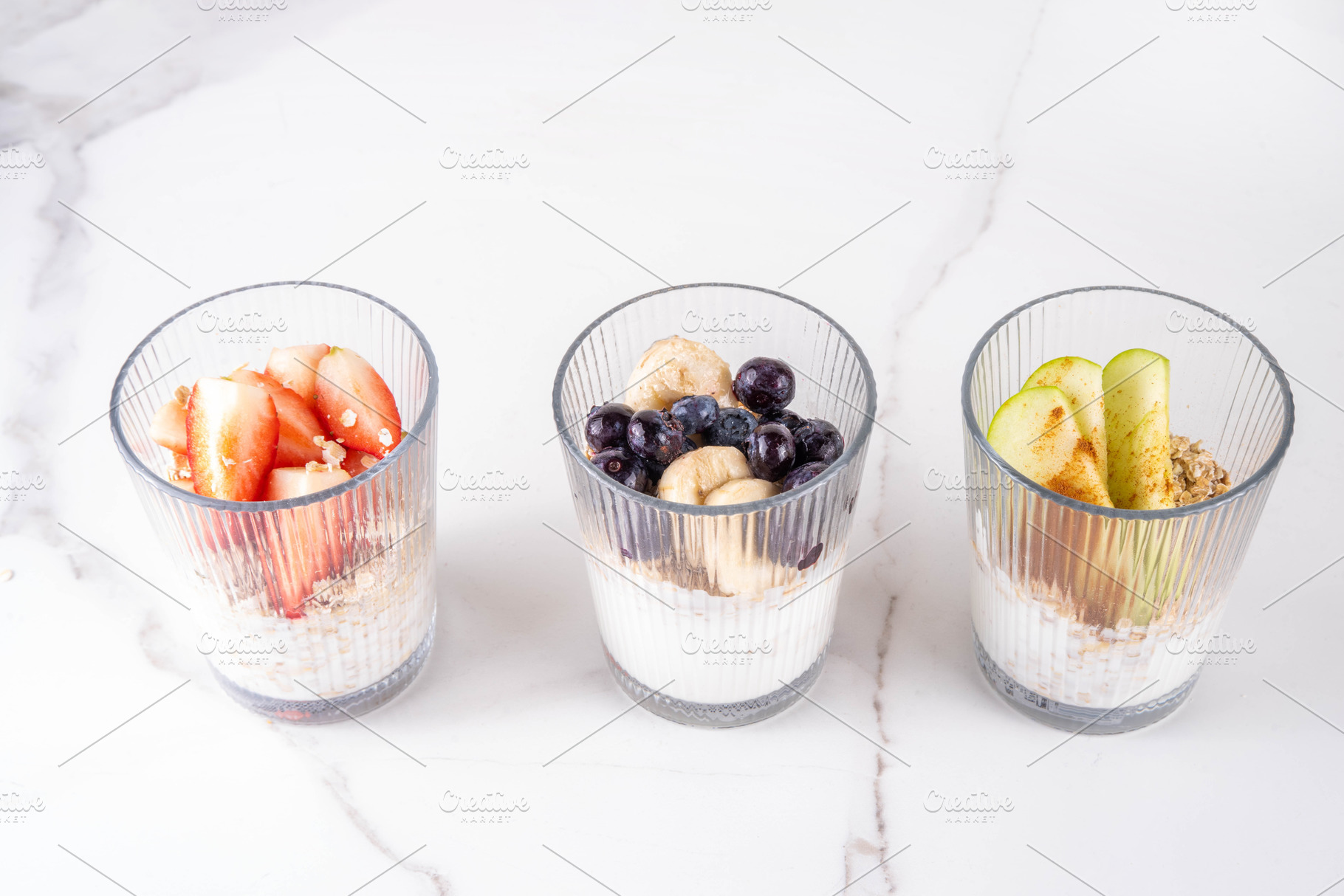 Three glasses of overnight oats with strawberry, green apples, b, a Food & Drink Photo by Rimma