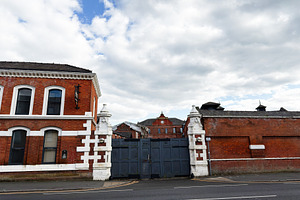 Historic red brick industrial gate and courtyard in Manchester,