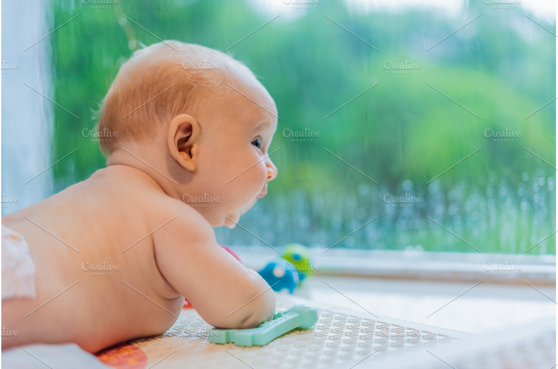 Little baby looking through a window, a Person Photo by Elizaveta Galitskaya
