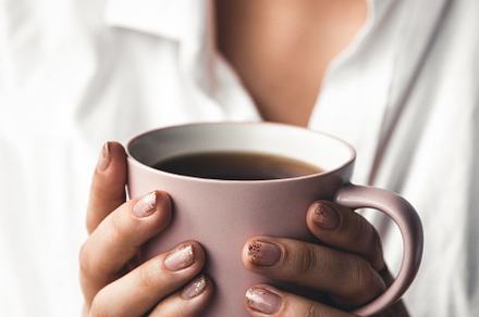 Woman holds morning coffee featuring woman, business, and design
