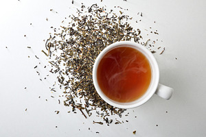 Hot infusion on white table with dried medicinal herbs, a Food & Drink Photo by Davizro's Market