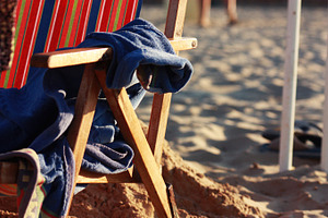 Beach chair featuring beach, towel, and italy