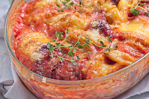 Sweet potato, parsnips and beet root au gratin, in glass dish, horizontal close, a Food & Drink Photo by iuliia_n