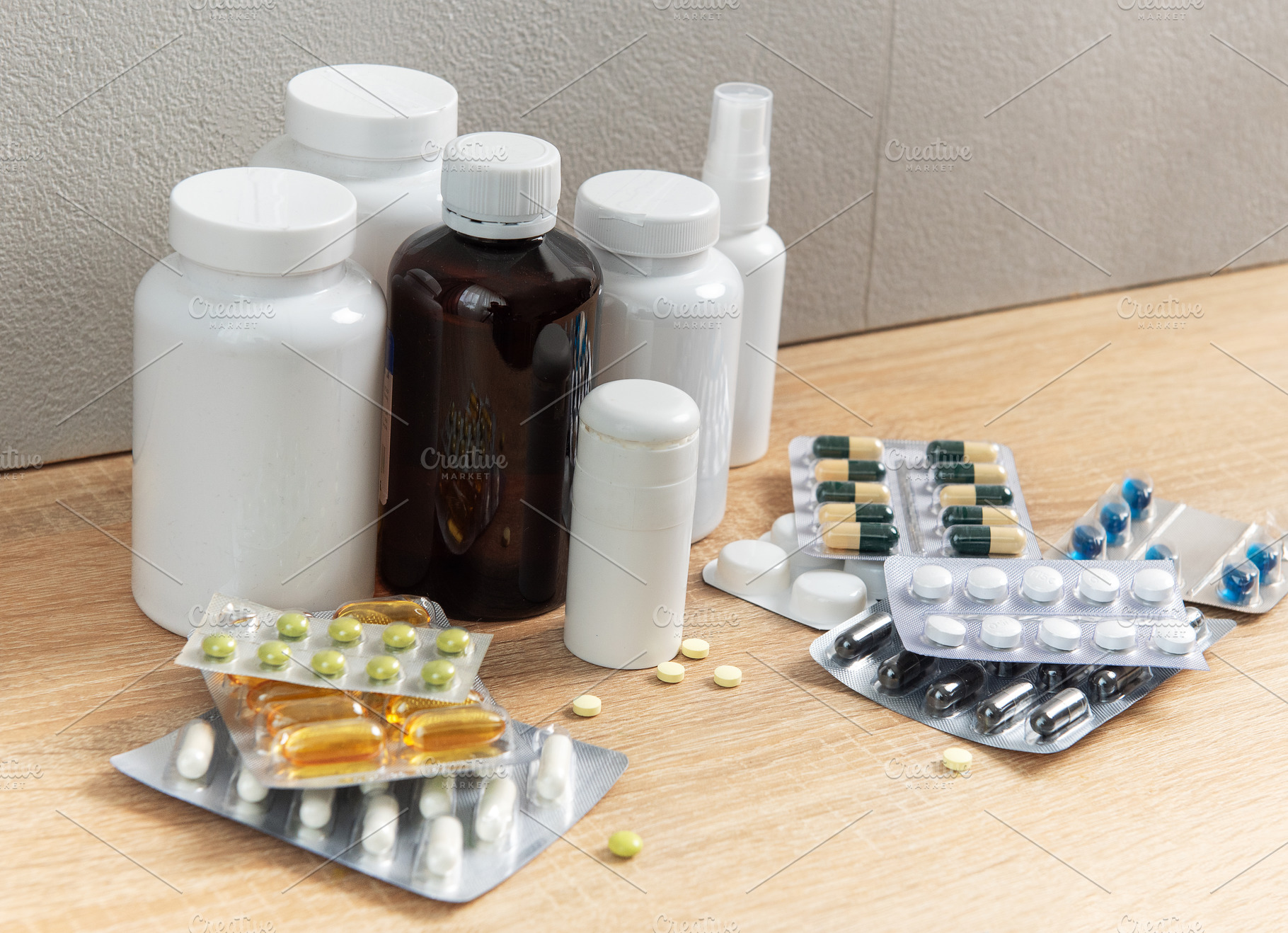 Medicine bottles and blister packs with various pills on wood, a Health & Medical Photo by Olena Rudo