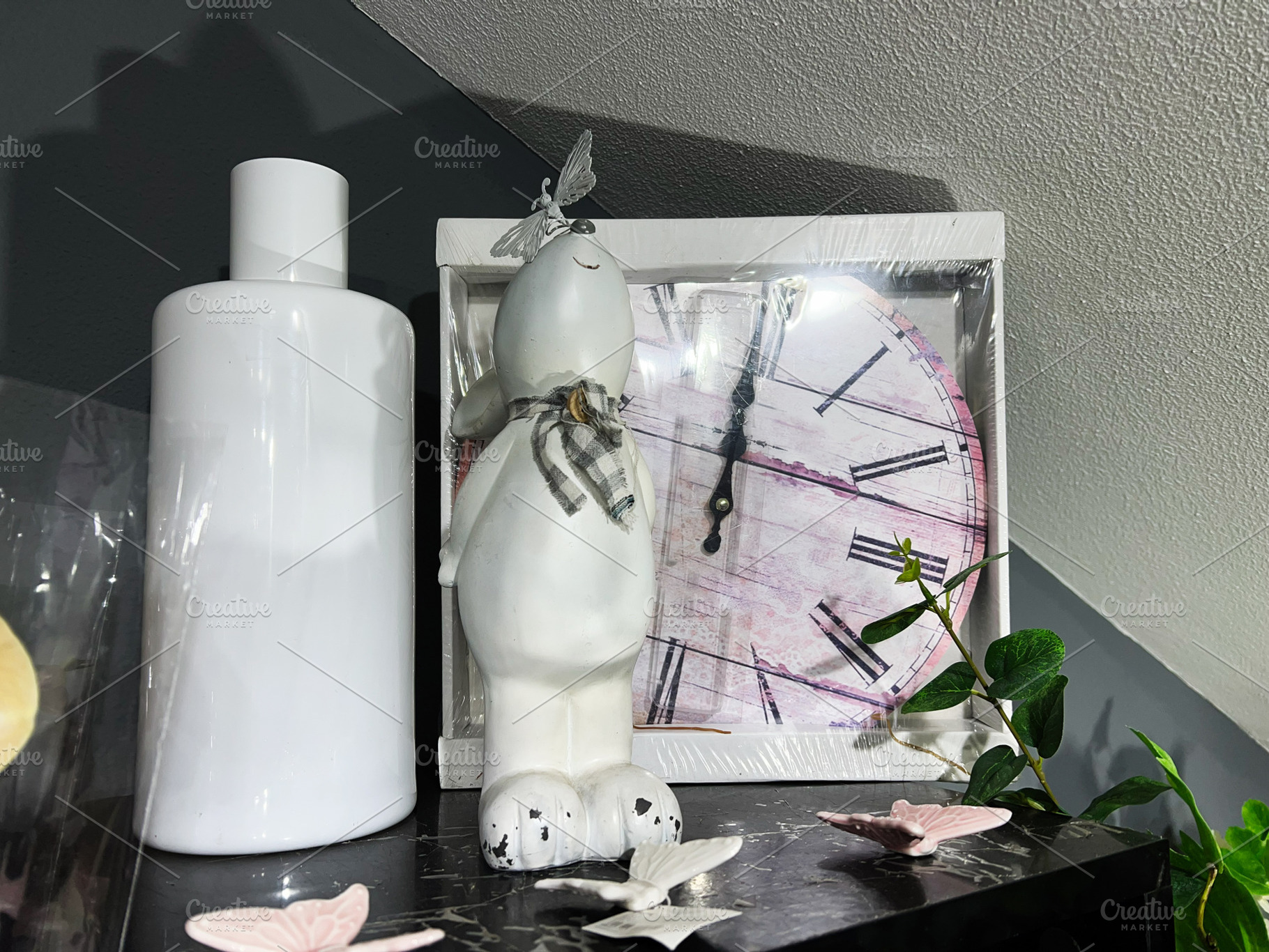 Stylish decorative arrangement with clock, sculpture, and greenery on a dark sh, a Photo by AS photostudio