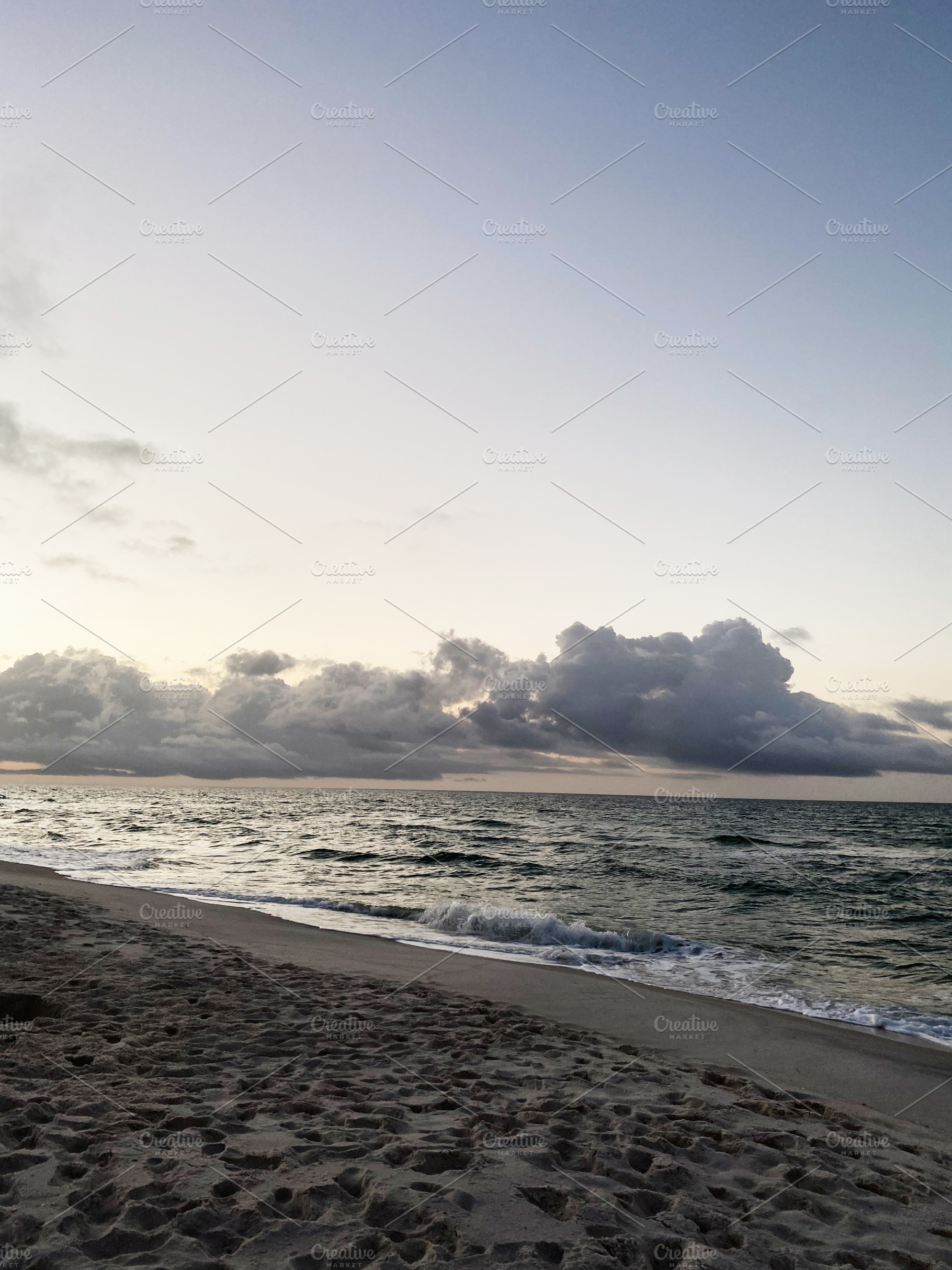 Serene Florida Pensacola beach at sunset with gentle waves and dramatic clouds, a Nature Photo by AS photostudio