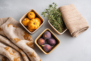 Fresh ingredients in reusable containers on a grey surface with a cozy textile, a Photo by AlyaAnd