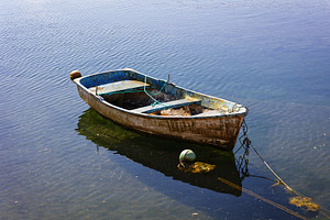 Small fishing boat moored and floati, a Transportation Photo by Perpis