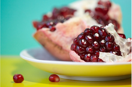 Close up of raw red ripe pomegranate, a Food & Drink Photo by Rohan Photography