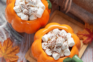 Warm autumn hot chocolate in pumpkin mugs with marshmallows, a Food & Drink Photo by Olena Rudo