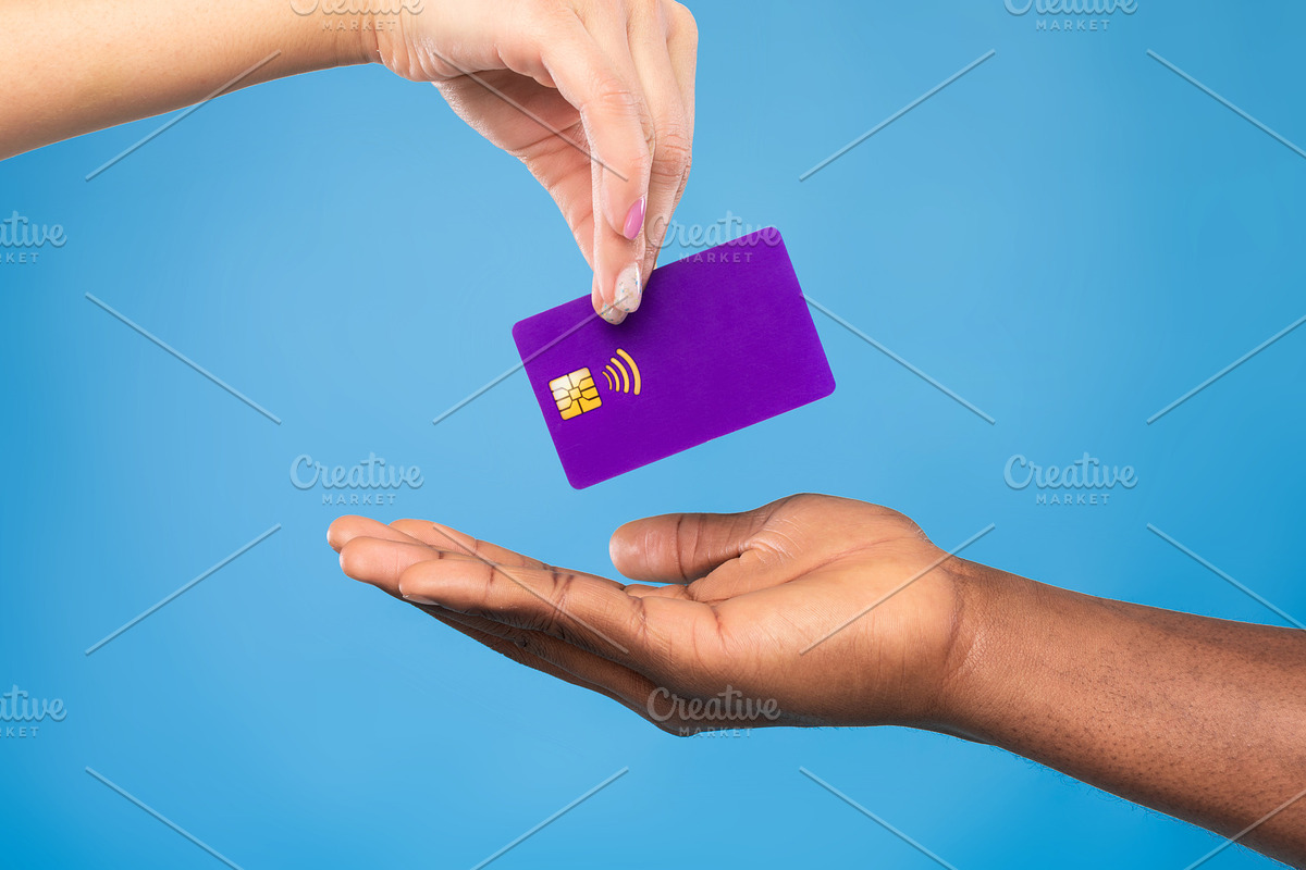 Cropped view of black man taking credit card from millennial woman on blue stud, a Photo by Prostock-Studio (Photo 1 of 2)