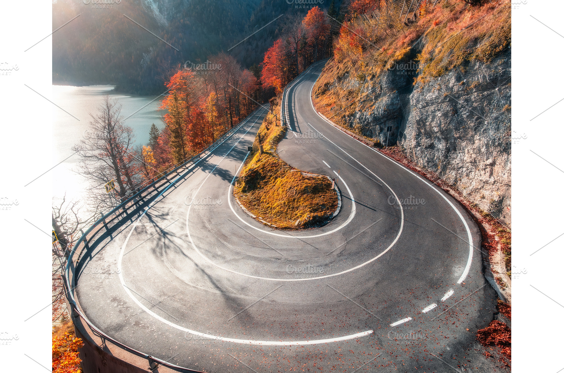 Aerial view of winding mountain road, a Nature Photo by den-belitsky