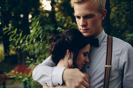 Groom gently embracing his bride stock photo containing couple and wedding, a Person Photo by Tekso