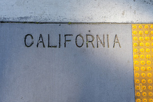 Engraved California text on a concrete sidewalk in San Francis, a Background Photo by GoodGoods