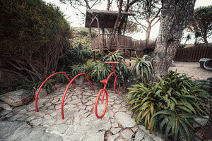 Red bike rack by treehouse garden, a Transportation Photo by SkyNext