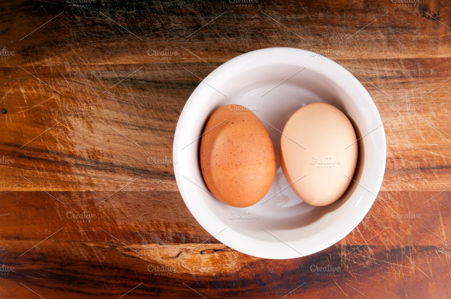 Two Eggs in Bowl On Wood Overhead, a Photo by THP Creative