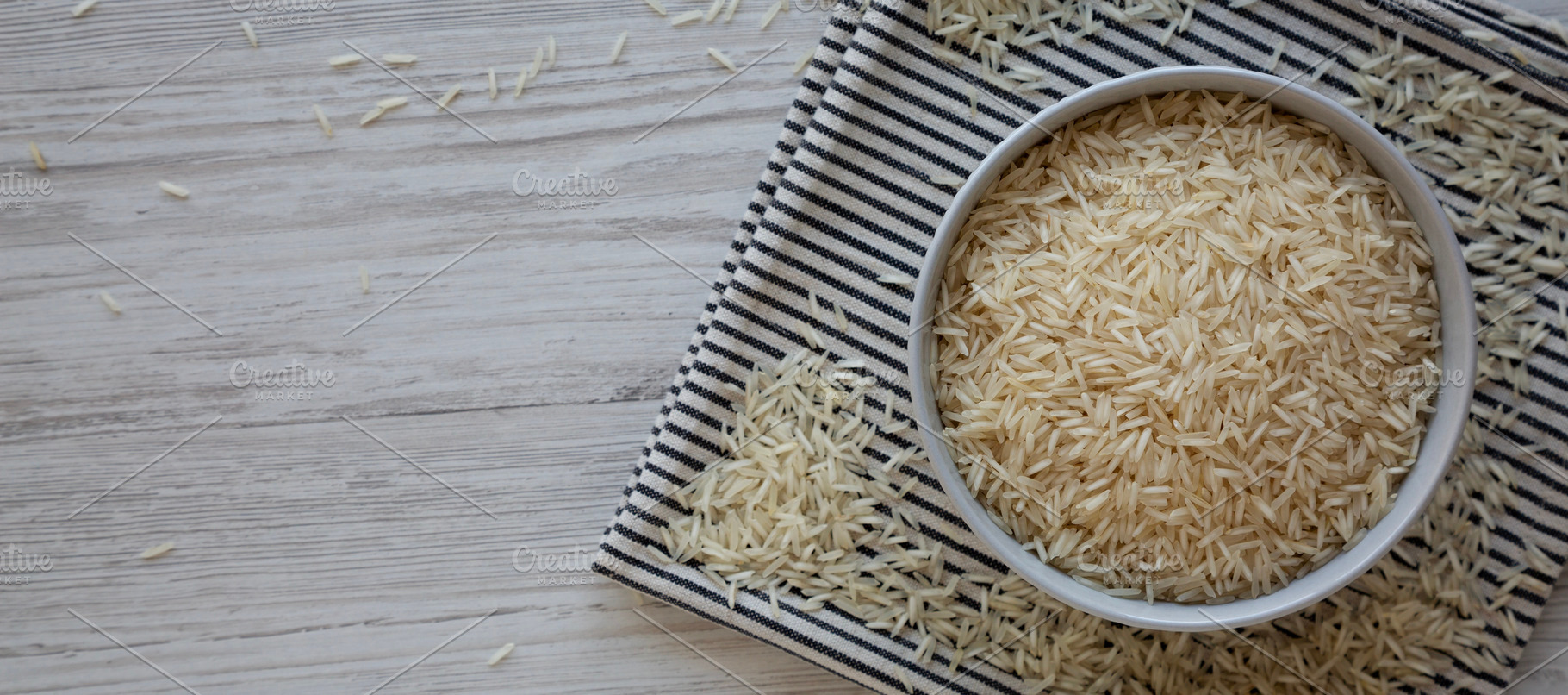 Uncooked White Organic Basmati Rice in a Bowl, top view. Copy sp, a Food & Drink Photo by LiudmylaChuhunova