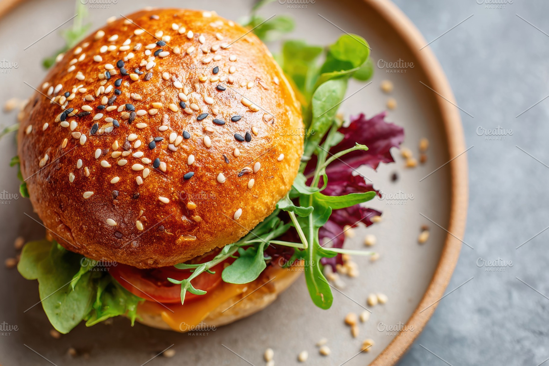 Delicious cheeseburger with fresh toppings, a Food & Drink Photo by AlyaAnd