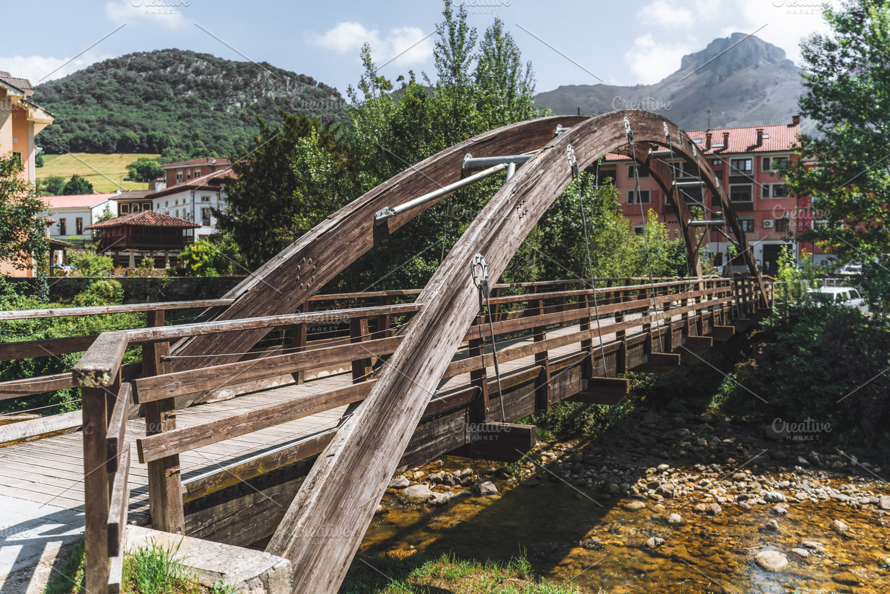 Rustic wooden arch bridge, stream, an Architecture Photo by SkyNext