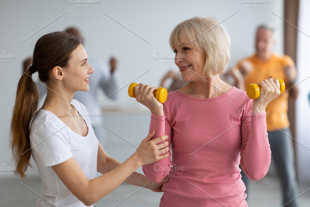 Fitness instructor assisting multiracial group of elderly people, a Photo by Prostock-Studio (Photo 1 of 2)
