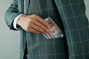 man putting Hungarian forints in pocket, a Photo by Nito