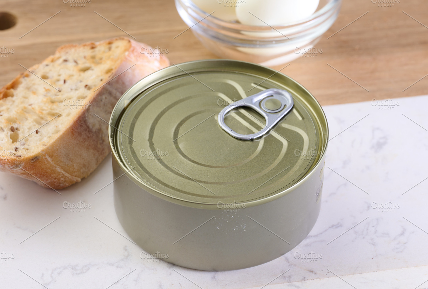 A closed tin can with a ring on a wooden surface, a Food & Drink Photo by ndanko