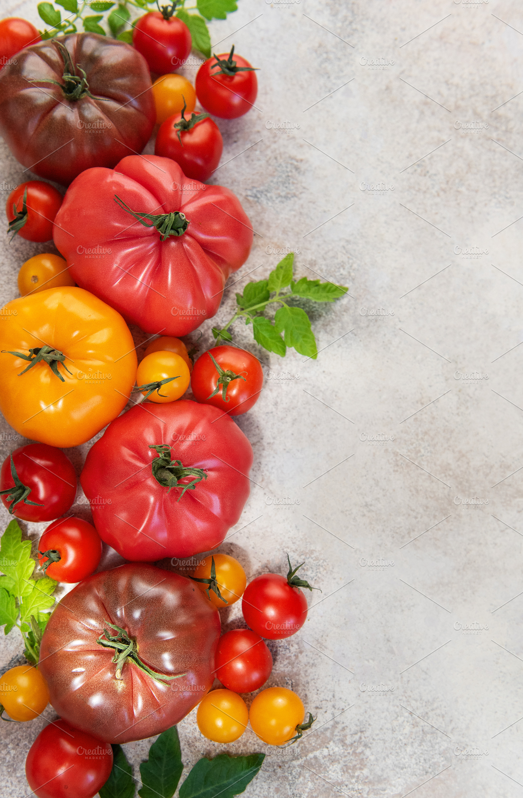 Colorful heirloom tomatoes creating a fresh garden harvest displ, a Food & Drink Photo by Olena Rudo