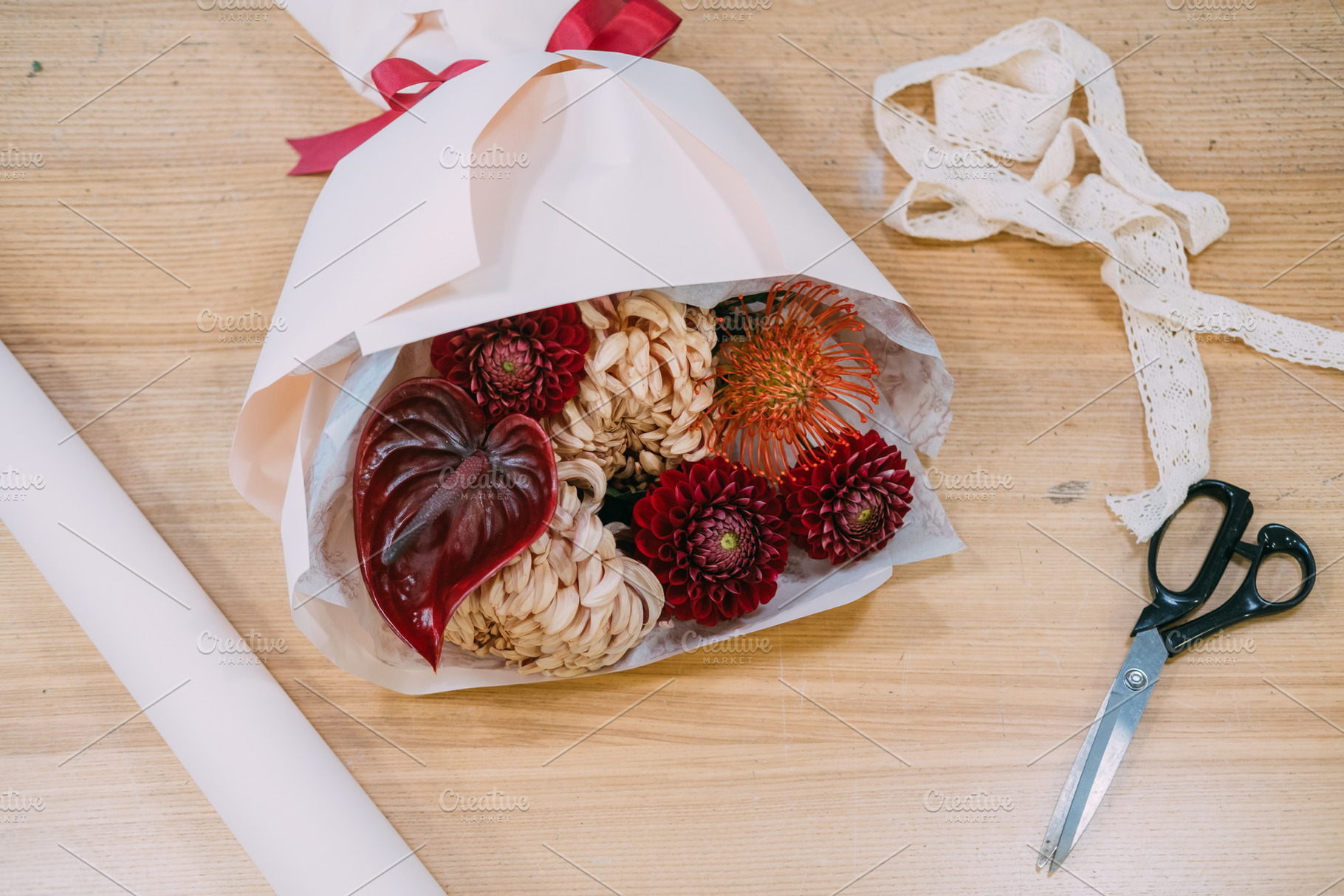 Flower craft bouquet preparing wrapped in paper, a Background Photo by Photo Drive Studio
