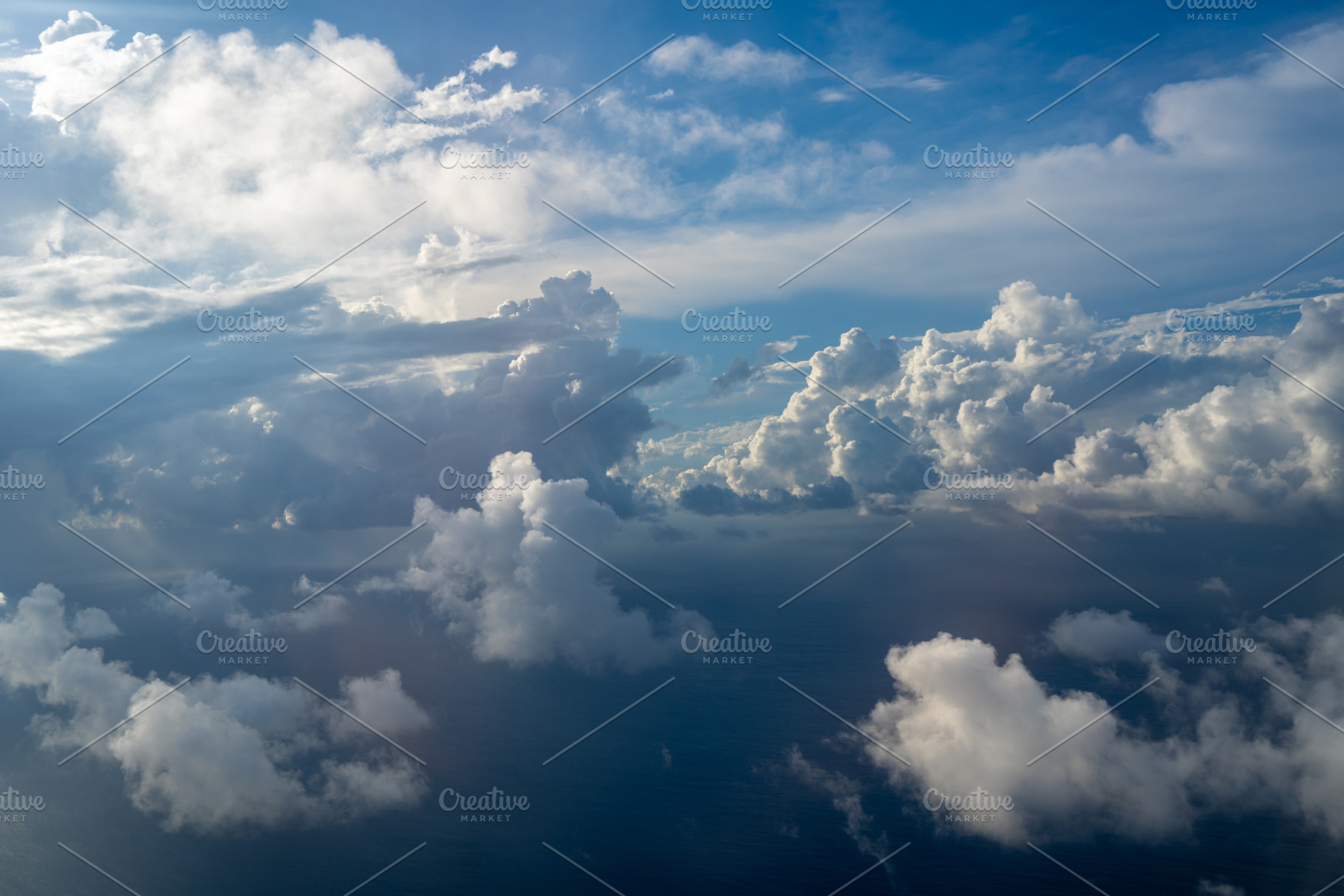 Dramatic sky with sunbeams and clouds seen from an airplane, a Nature Photo by GoodGoods