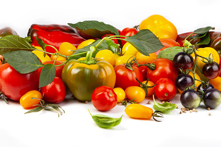 Assorted tomatoes and vegetables isolated on white background. P