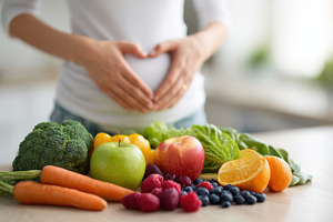 Woman making heart shape over stomach with fresh produce, a Food & Drink Photo by AlyaAnd