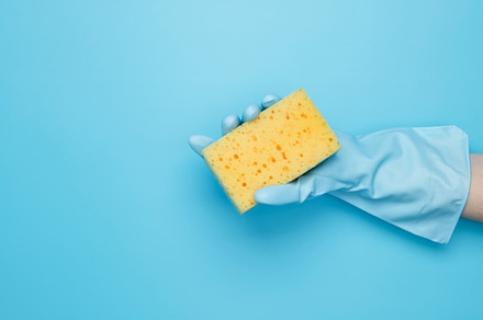 Womans hand in rubber glove holds yellow dishwashing sponge. House cleaning. Co, a Photo by matucha