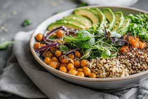 Vibrant Vegan Buddha Bowl with Avocado, Quinoa, and Chickpeas on Rustic Grey Ba, a Food & Drink Photo by Ocean Digital Art