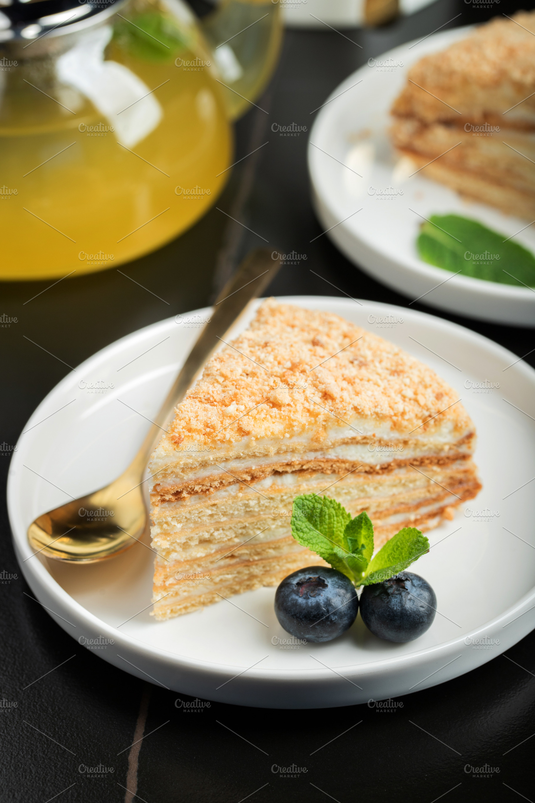 Medovik. Honey cake made from honey cakes with whipped sour cream, decorated wi, a Food & Drink Photo by Budarinphoto