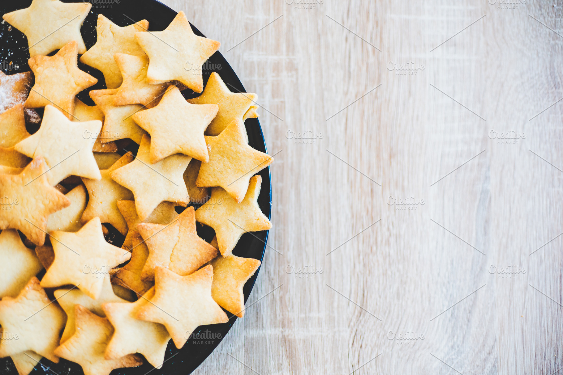 Butter cookies in black ceramic dish featuring background, baked, and bakery, a Food & Drink Photo by MadPhotos