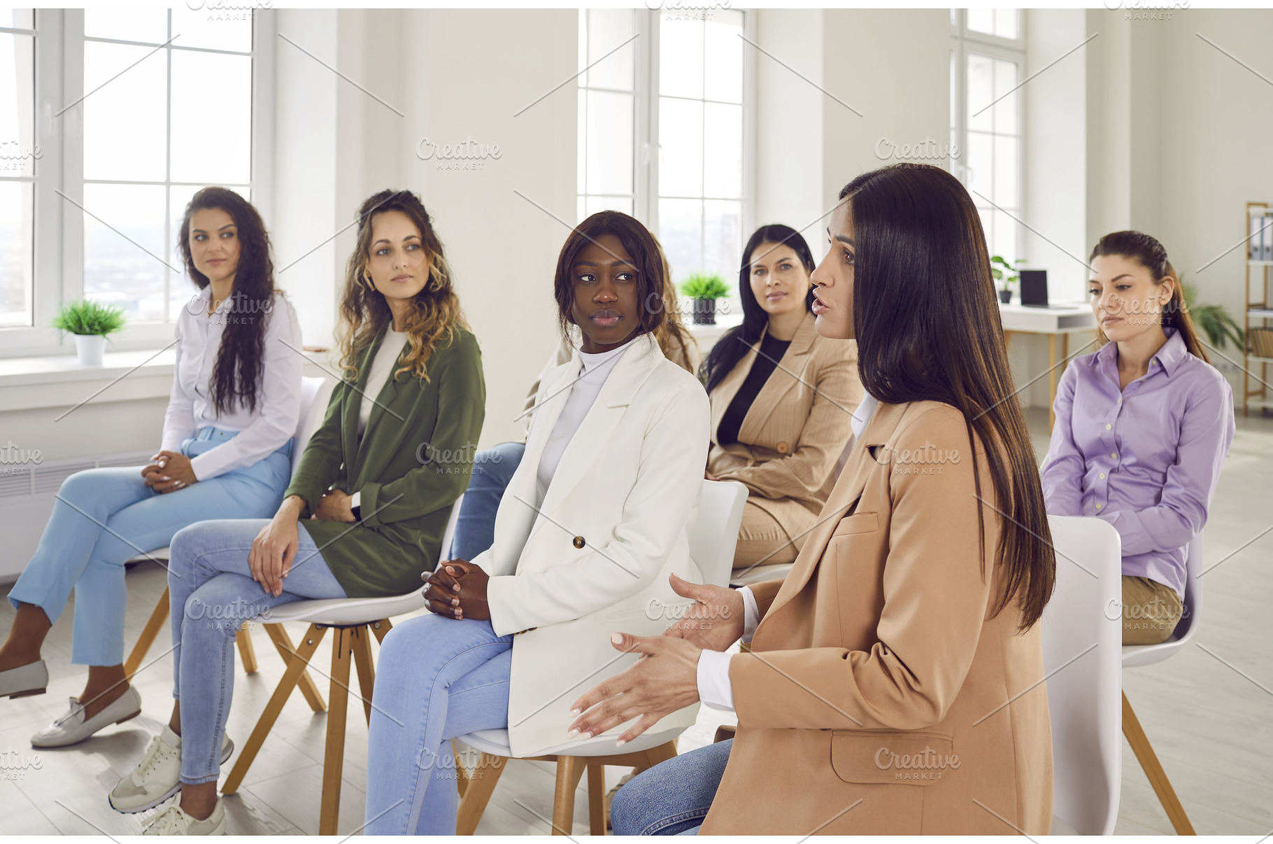 Diverse women gathered together, a Business Photo by StudioRomantic
